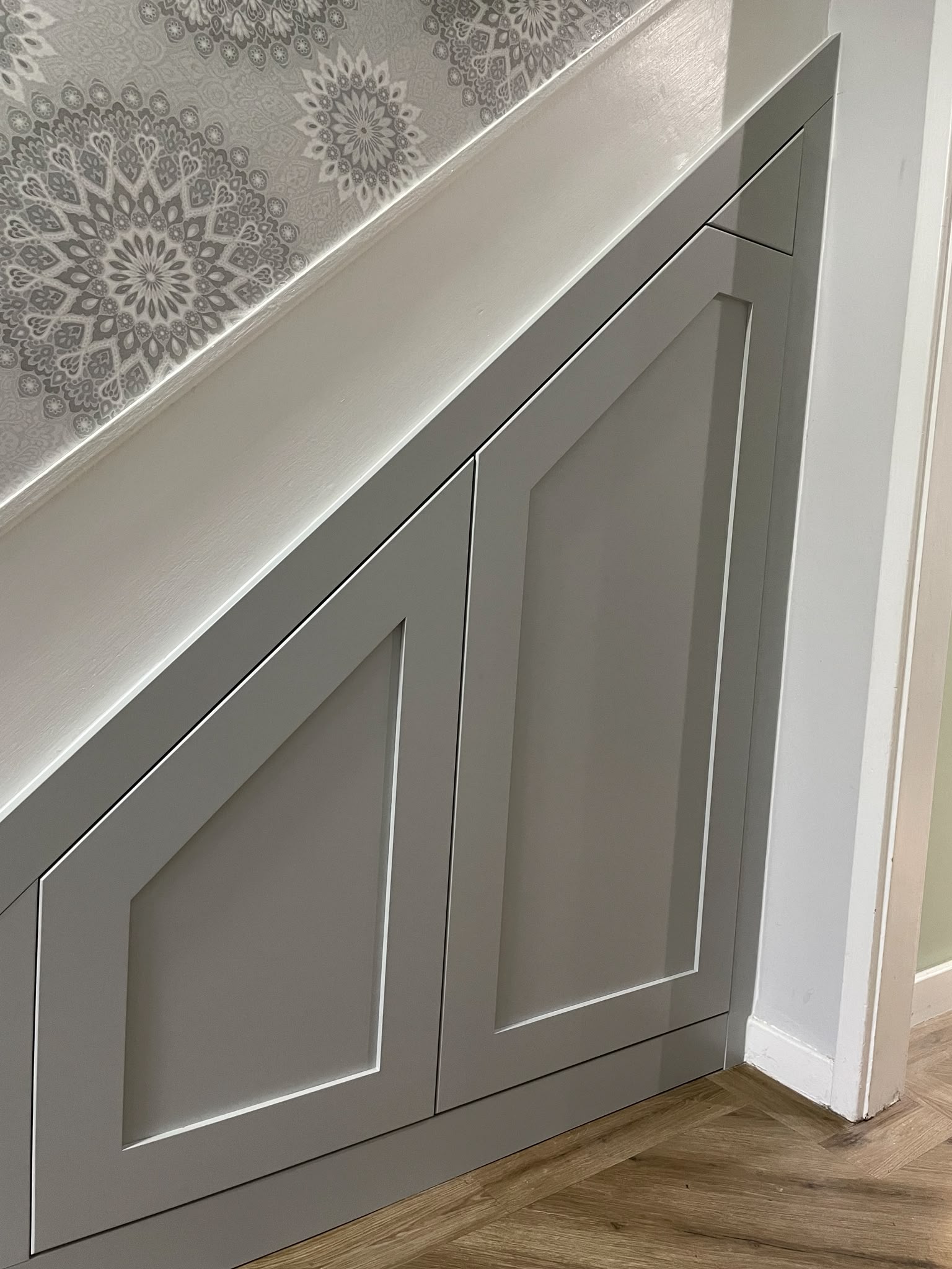 Bespoke under-stairs storage cupboards fitted in a Morpeth hallway