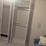Bespoke bedroom wardrobes with integrated shelving and hanging space by Interiors by Build NE, NE12