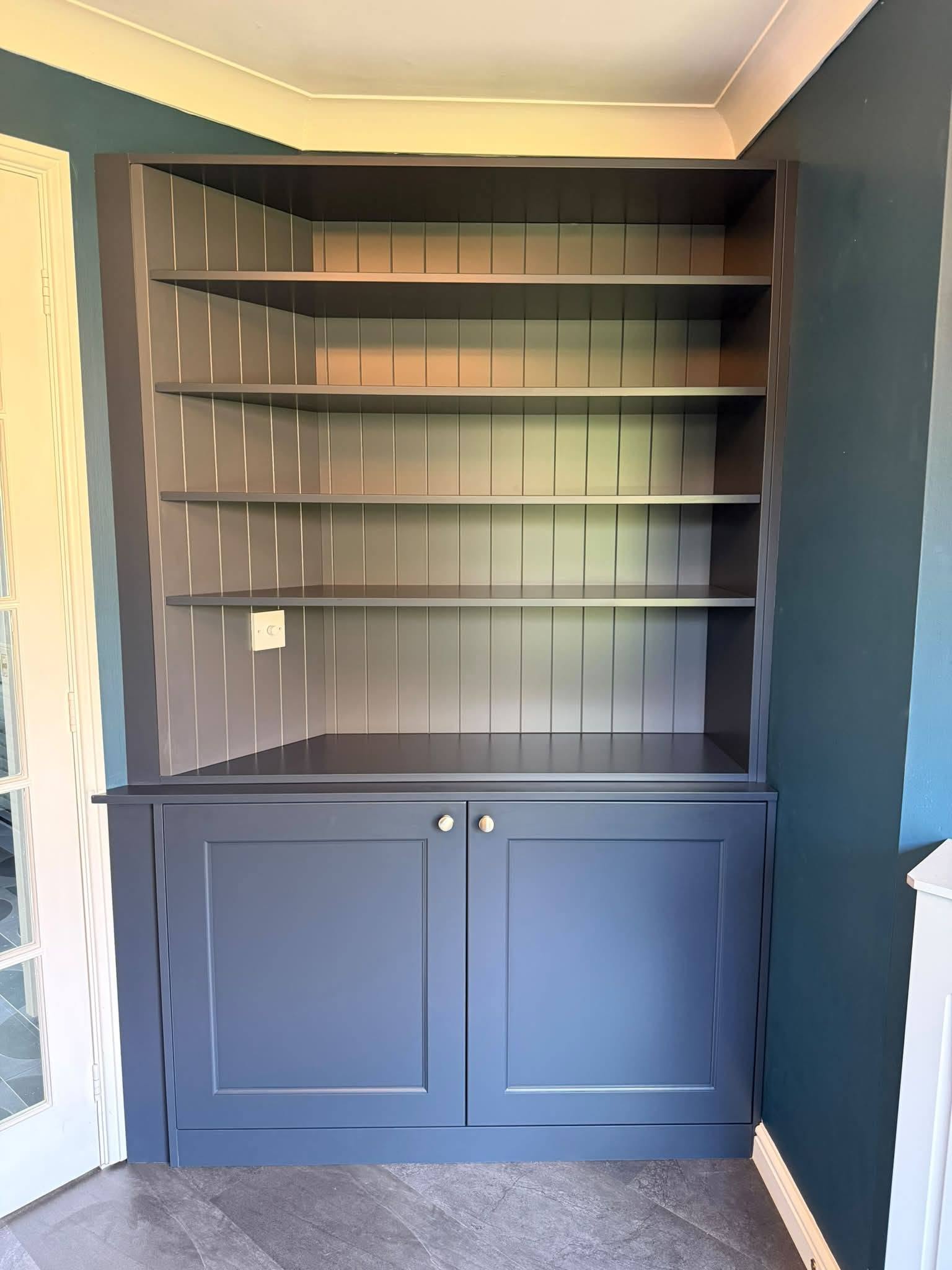 Fitted dresser and shelving unit finished in navy blue by Interiors by Build NE