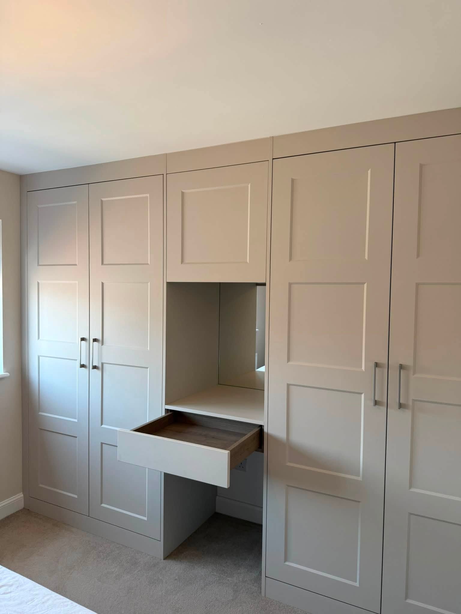Fitted wardrobes with a mirrored dressing nook, installed in a Morpeth-area home by Interiors By Build NE