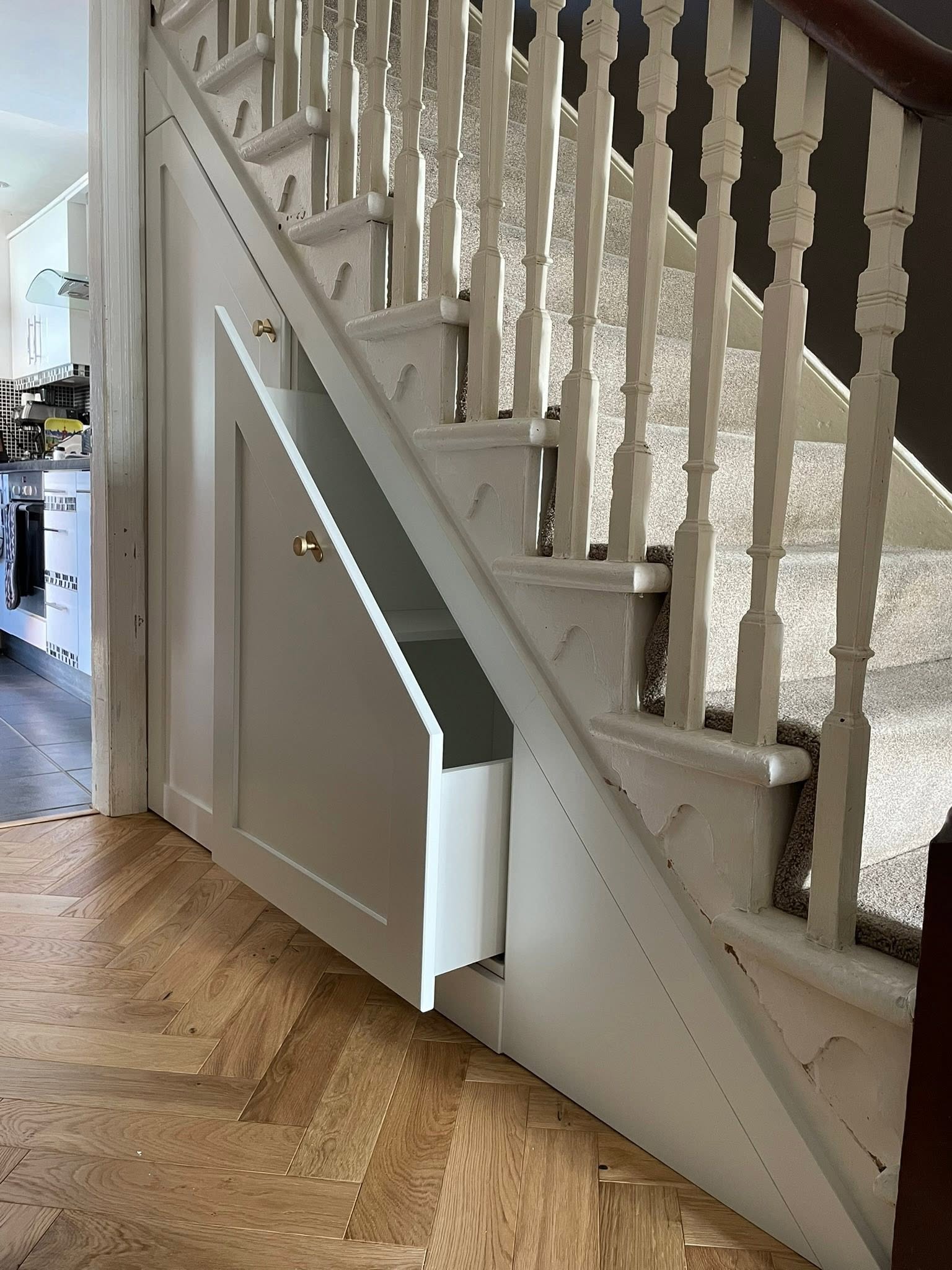 Under-stairs storage cupboard with pull-out drawer, installed by Interiors by Build NE in Wallsend
